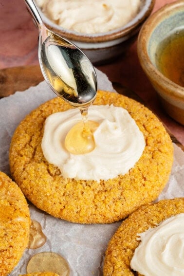vegan cornbread cookies with agave buttercream and a drizzle of agave on top
