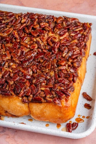 close up of maple pecan sticky buns in a sheet pan