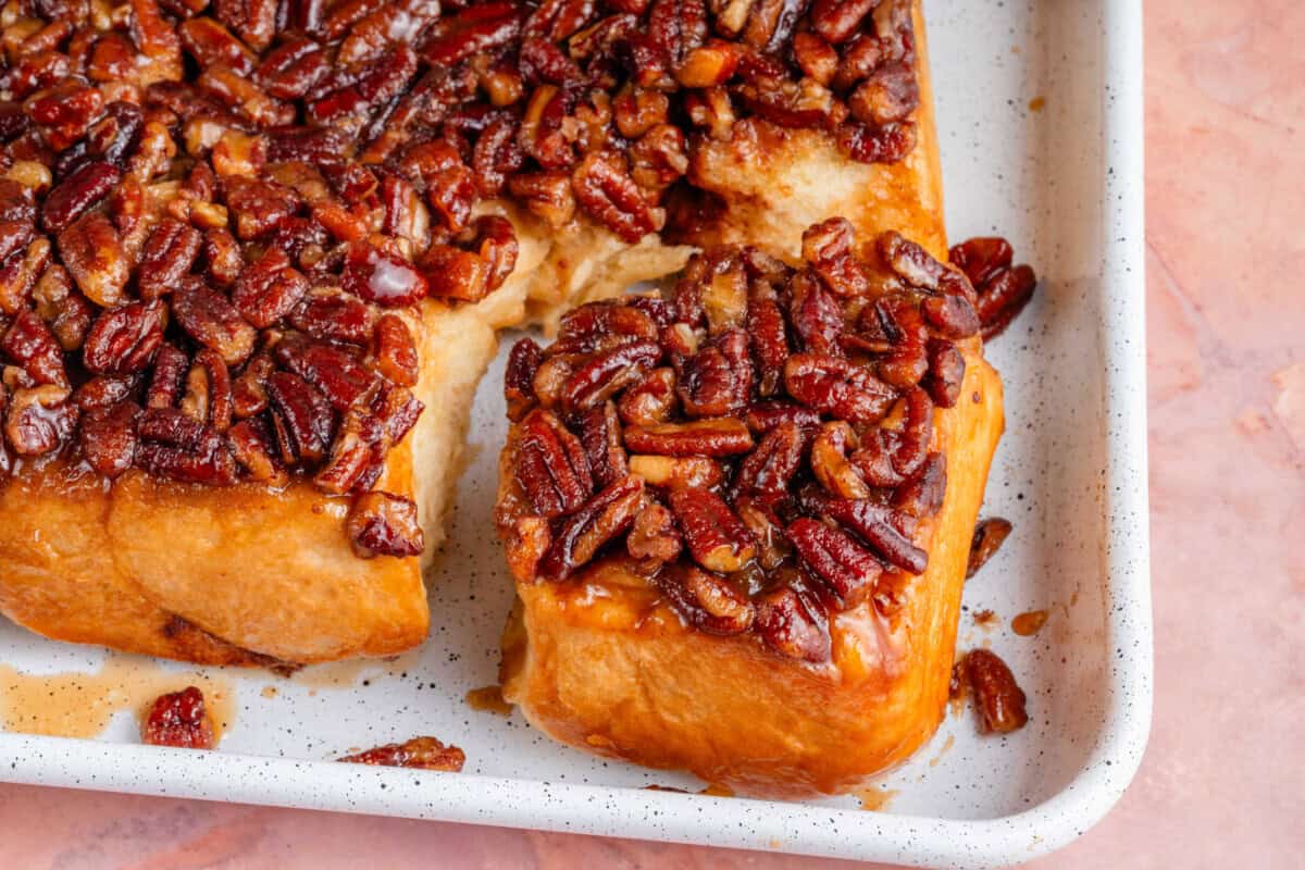 close up of maple pecan sticky buns in a sheet pan