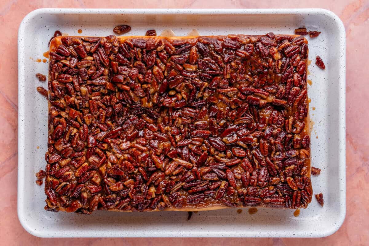 overhead of maple pecan sticky buns in a white sheet pan