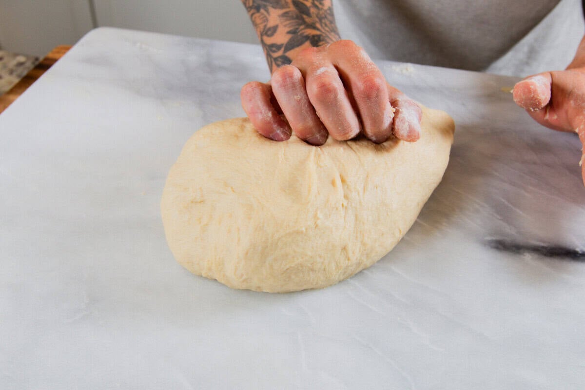 kneading dough on marble slab